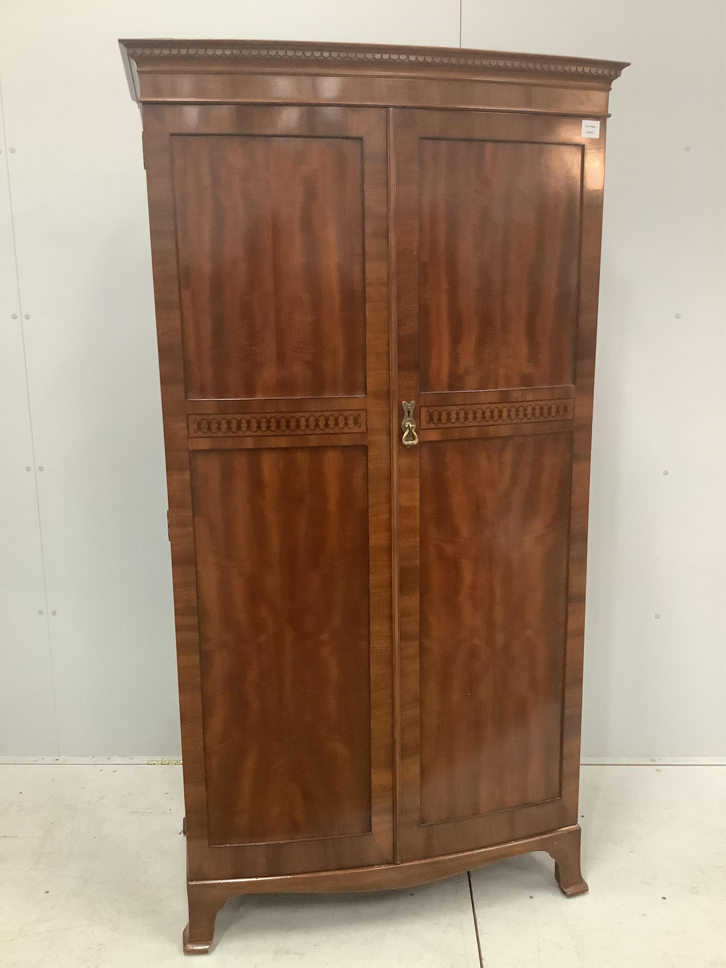 An Edwardian inlaid mahogany bowfront wardrobe, Maple & Co label, width 96cm, depth 53cm, height 182cm. Condition - good